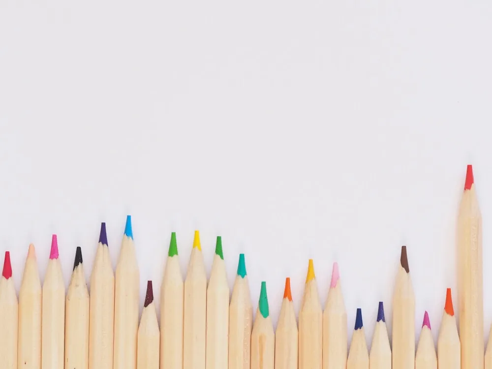 Row of colored pencils on a white background